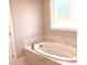Modern bathroom featuring a large, soaking tub with stylish fixtures and a serene ambiance at 3913 Cedar Knolls # 7, Youngsville, NC 27596