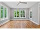 Serene bedroom featuring hardwood floors, large windows, and access to a private outdoor space at 3913 Cedar Knolls # 7, Youngsville, NC 27596
