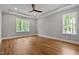Bright bedroom with hardwood floors, a ceiling fan, and windows overlooking the trees at 3913 Cedar Knolls # 7, Youngsville, NC 27596