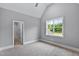 Bedroom with gray walls, carpet, and a large window with a view of green trees at 3913 Cedar Knolls # 7, Youngsville, NC 27596