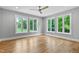 Bright bedroom with hardwood floors and multiple windows, offering views of the lush, green outdoors at 3913 Cedar Knolls # 7, Youngsville, NC 27596