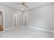 Bedroom with neutral gray walls, carpet, a ceiling fan, and entrances to other areas of the home at 3913 Cedar Knolls # 7, Youngsville, NC 27596