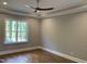 This bedroom features hardwood floors, ceiling fan, recessed lights and a large window at 3913 Cedar Knolls # 7, Youngsville, NC 27596