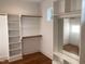 Walk-in closet offering custom shelves, cabinets, and a mirror for optimal organization at 3913 Cedar Knolls # 7, Youngsville, NC 27596