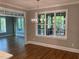 Dining room features a modern chandelier, hardwood flooring and abundant natural light at 3913 Cedar Knolls # 7, Youngsville, NC 27596