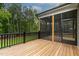 View of outdoor deck with black railing overlooking lush green trees and grass at 3913 Cedar Knolls # 7, Youngsville, NC 27596