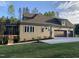 Exterior view of a home with a screened porch, patio, and large yard with a view of mature trees at 3913 Cedar Knolls # 7, Youngsville, NC 27596