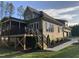 Exterior view of a home with a screened porch, patio, and large yard with a view of mature trees at 3913 Cedar Knolls # 7, Youngsville, NC 27596