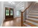 Bright foyer featuring hardwood floors, staircase, and glass double doors with views of the outdoors at 3913 Cedar Knolls # 7, Youngsville, NC 27596