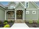 Front entrance featuring a stone facade, a wooden door, and manicured landscaping at 3913 Cedar Knolls # 7, Youngsville, NC 27596