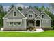 Close up of a home's facade featuring gray siding, stone accents, and well-kept landscaping at 3913 Cedar Knolls # 7, Youngsville, NC 27596
