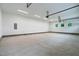 A spacious three-car garage with painted walls, bright lighting, and natural light from three small windows at 3913 Cedar Knolls # 7, Youngsville, NC 27596