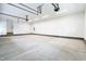 Spacious garage featuring bright lighting, painted walls, and a single door that leads to the yard at 3913 Cedar Knolls # 7, Youngsville, NC 27596