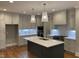Modern kitchen with stainless steel appliances, gray cabinetry, and a quartz island at 3913 Cedar Knolls # 7, Youngsville, NC 27596
