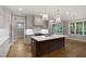 Spacious open kitchen boasts modern appliances, a large island, and stylish pendant lighting at 3913 Cedar Knolls # 7, Youngsville, NC 27596