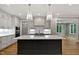 Stunning kitchen features custom cabinetry, quartz countertops, and a central island with sink at 3913 Cedar Knolls # 7, Youngsville, NC 27596