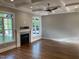 Spacious living room showcasing hardwood floors, a cozy fireplace, and large windows for natural light at 3913 Cedar Knolls # 7, Youngsville, NC 27596
