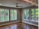 Bright and airy living room featuring large windows, beautiful hardwood floors, and modern ceiling fan at 3913 Cedar Knolls # 7, Youngsville, NC 27596