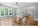 Open living room with hardwood floors, large windows, and a patio door, offering natural light at 3913 Cedar Knolls # 7, Youngsville, NC 27596