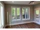 Bright and airy living room featuring large windows, beautiful hardwood floors, and modern lighting at 3913 Cedar Knolls # 7, Youngsville, NC 27596
