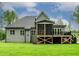 Back of a home with a screened porch, well-maintained lawn, and neutral gray siding at 3913 Cedar Knolls # 7, Youngsville, NC 27596