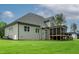 Rear view of a home featuring a screened porch, spacious lawn, and gray siding at 3913 Cedar Knolls # 7, Youngsville, NC 27596