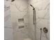 This spacious walk-in shower features a handheld shower head, built-in shelves, and sleek fixtures at 3913 Cedar Knolls # 7, Youngsville, NC 27596