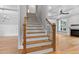 Staircase with wood treads, gray risers, and a black metal railing, adjacent to an open living area at 3913 Cedar Knolls # 7, Youngsville, NC 27596