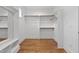 Organized walk-in closet with shelving, wood floors, and ample storage space at 3913 Cedar Knolls # 7, Youngsville, NC 27596