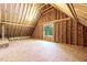 Unfinished attic space featuring exposed beams, a window and wood flooring at 3923 Cedar Knolls Dr # 12, Youngsville, NC 27596