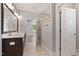 Bathroom with double sink vanity, large mirror, glass shower and open doorway to bedroom at 3923 Cedar Knolls Dr # 12, Youngsville, NC 27596