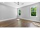 Bedroom with neutral gray walls, hardwood floors, a ceiling fan and natural light from 2 windows at 3923 Cedar Knolls Dr # 12, Youngsville, NC 27596
