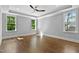 Bright and airy bedroom with hardwood floors, large windows, and a ceiling fan at 3923 Cedar Knolls Dr # 12, Youngsville, NC 27596