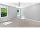 Neutral bedroom with a ceiling fan and two large, sun-filled windows at 3923 Cedar Knolls Dr # 12, Youngsville, NC 27596
