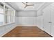 Bedroom with hardwood floors, neutral gray walls, white wainscotting and large window at 3923 Cedar Knolls Dr # 12, Youngsville, NC 27596