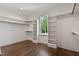 Spacious walk-in closet with custom shelving, wood floors and large window providing natural light at 3923 Cedar Knolls Dr # 12, Youngsville, NC 27596