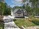 Stunning two-story home featuring a long driveway, mature trees, and a well-manicured lawn at 3923 Cedar Knolls Dr # 12, Youngsville, NC 27596