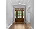 Elegant foyer featuring hardwood floors, a stylish front door, and white trim at 3923 Cedar Knolls Dr # 12, Youngsville, NC 27596