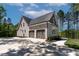 Spacious three-car garage with carriage-style doors and ample parking space at 3923 Cedar Knolls Dr # 12, Youngsville, NC 27596