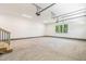 Bright two-car garage with concrete floor, painted walls, natural light and wooden stairs at 3923 Cedar Knolls Dr # 12, Youngsville, NC 27596