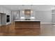 Modern kitchen island with seating, pendant lights, and an adjacent dining area at 3923 Cedar Knolls Dr # 12, Youngsville, NC 27596
