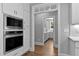 Kitchen with stainless appliances, white cabinetry, and hardwood floors leading to a butler's pantry at 3923 Cedar Knolls Dr # 12, Youngsville, NC 27596