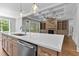 Open concept kitchen with a large island, stainless steel appliances, and stone fireplace visible from the island at 3923 Cedar Knolls Dr # 12, Youngsville, NC 27596