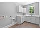 Laundry room with white cabinets, countertop, sink and window with a verdant view at 3923 Cedar Knolls Dr # 12, Youngsville, NC 27596