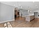 Open living area with adjacent dining and kitchen areas under a coffered ceiling at 3923 Cedar Knolls Dr # 12, Youngsville, NC 27596