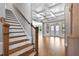 Living room showcases stairs, hardwood floors, coffered ceilings, and natural light at 3923 Cedar Knolls Dr # 12, Youngsville, NC 27596