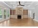 Bright living room with stone fireplace and built-in cabinets; access to the outdoor balcony at 3923 Cedar Knolls Dr # 12, Youngsville, NC 27596