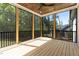 Covered screened porch featuring a wood plank ceiling and black metal railing overlooking wooded backyard at 3923 Cedar Knolls Dr # 12, Youngsville, NC 27596