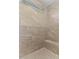 Modern tiled shower with built in bench, window and river rock floor at 3923 Cedar Knolls Dr # 12, Youngsville, NC 27596
