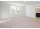 Spacious bedroom with neutral carpet, large windows offering ample natural light, and a closet at 3935 Willow Gate Way, Knightdale, NC 27604